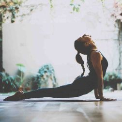 Person performing a deep stretch on a mat, highlighting flexibility and fitness